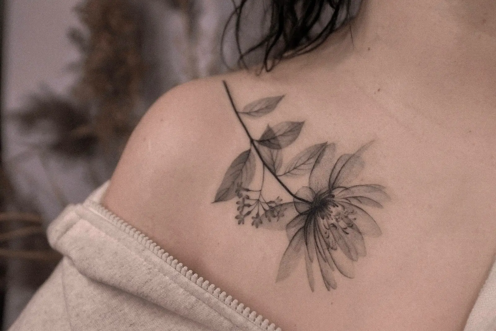 Delicate botanical tattoo across the shoulder