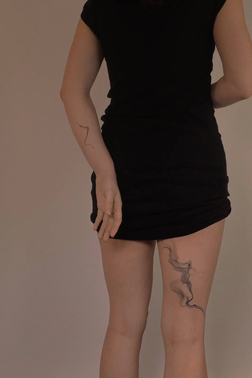 Ethereal flowing tattoo on the thigh