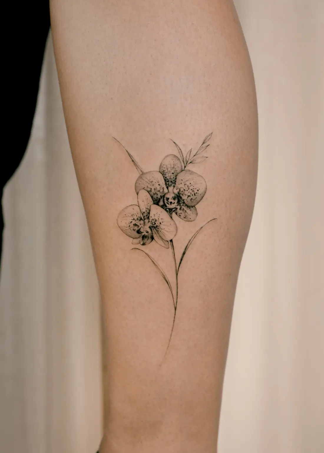 Delicate fine line orchid tattoo