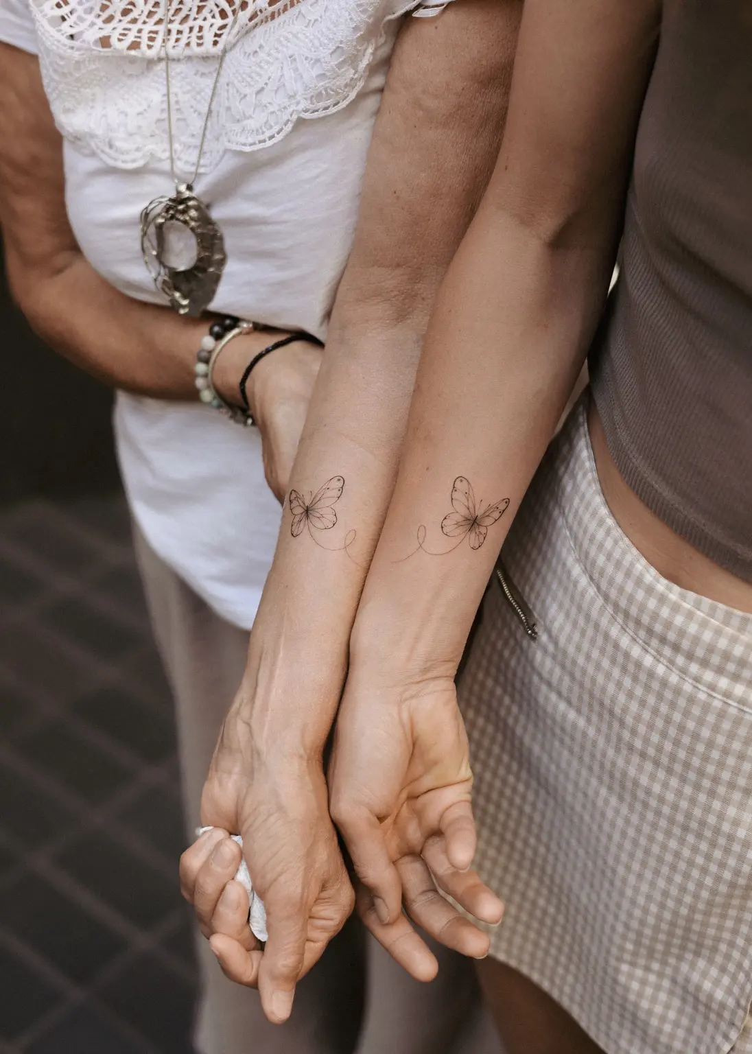 Matching fine line butterfly tattoos