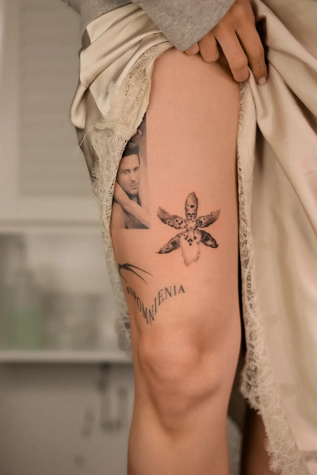 Butterfly and portrait collage tattoo on the thigh
